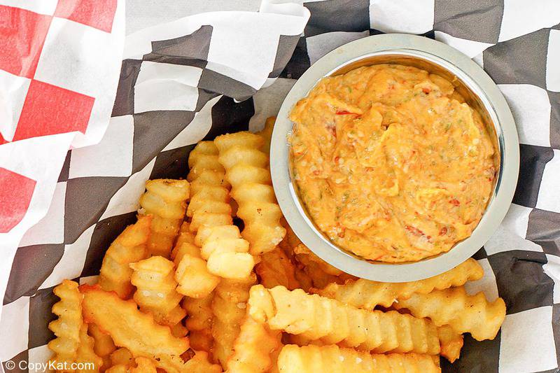 a bowl of homemade Whataburger creamy pepper sauce in a basket with fries