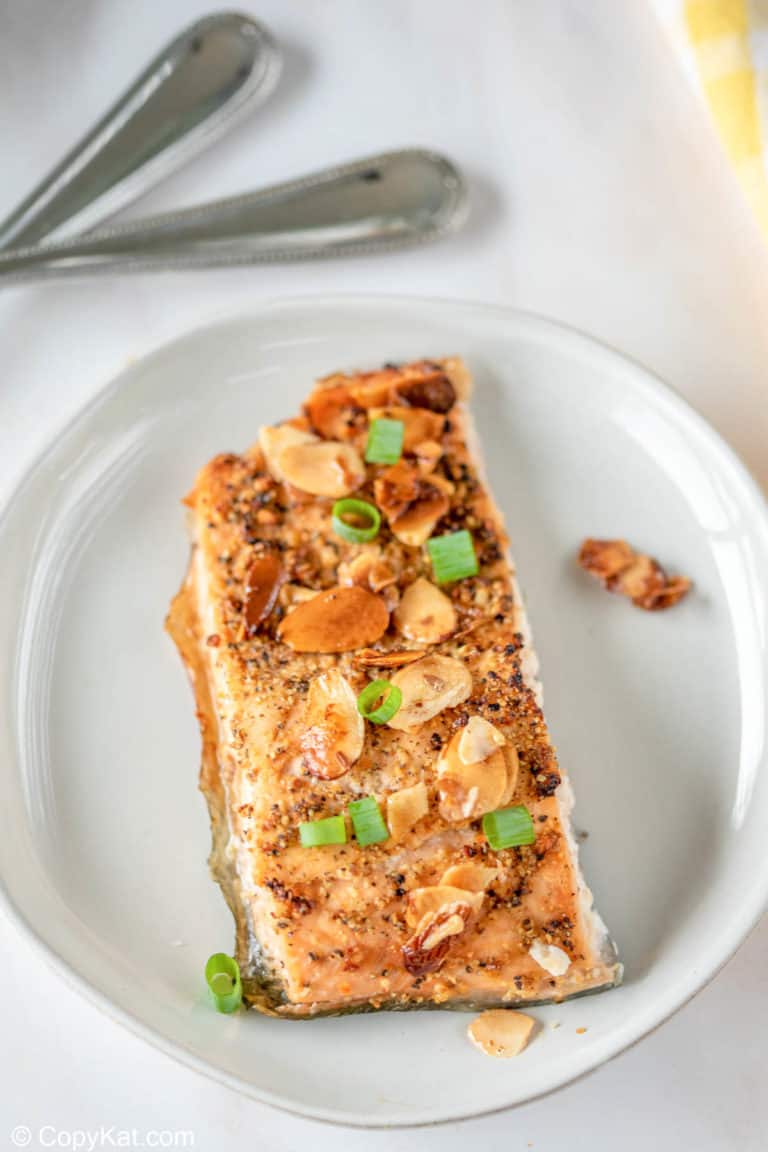 air fried salmon almondine on a white plate
