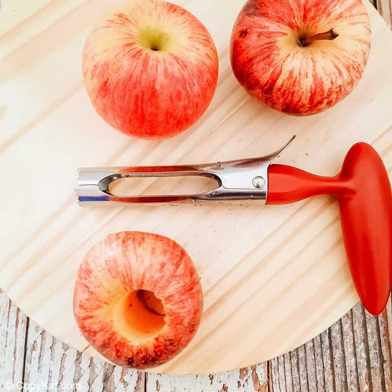 three apples and an apple corer