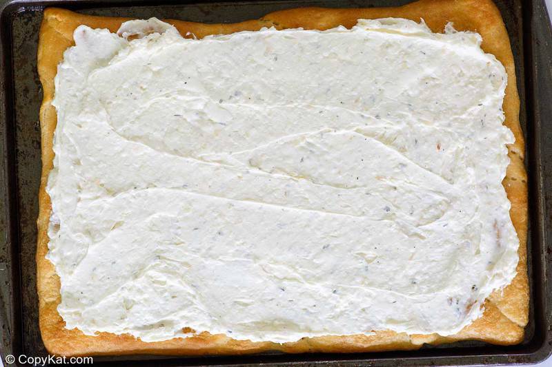 baked crescent roll pizza crust topped with cream cheese mixture