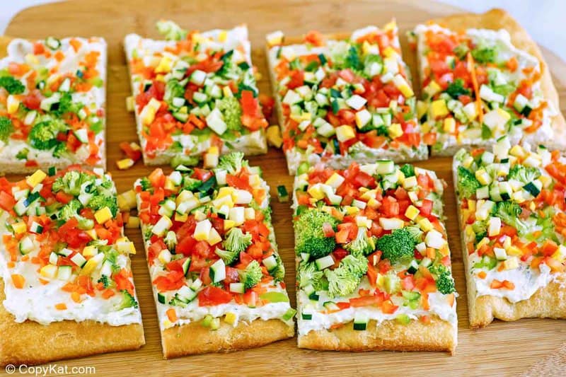 crescent roll veggie pizza slices on a cutting board