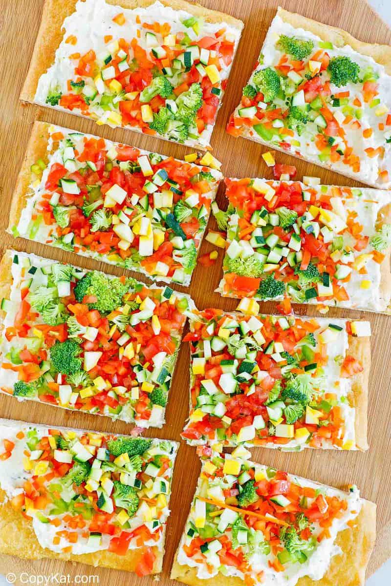 overhead view of crescent roll veggie patch pizza on a cutting board