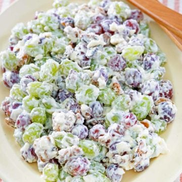grape salad and salad tongs on a platter