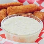 a bowl of homemade Red Lobster tartar sauce on a tray with fish sticks
