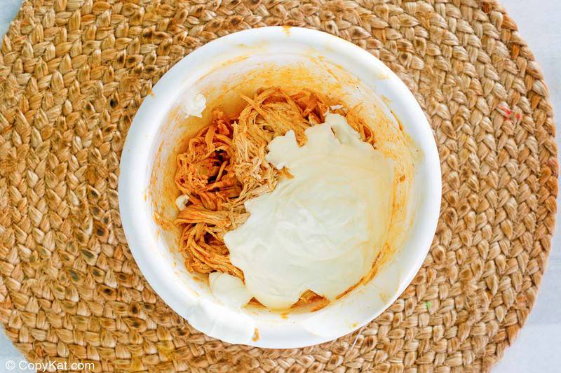 shredded enchilada chicken and sour cream in a bowl