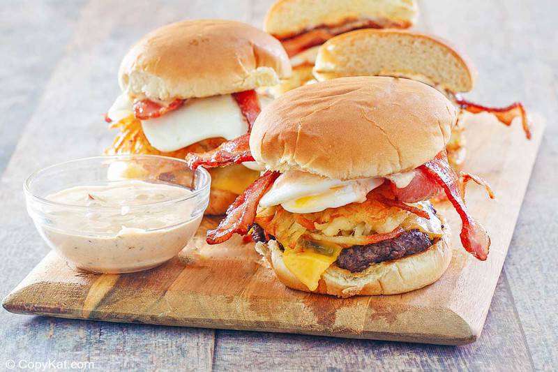 homemade Whataburger breakfast burger and creamy pepper sauce on a board