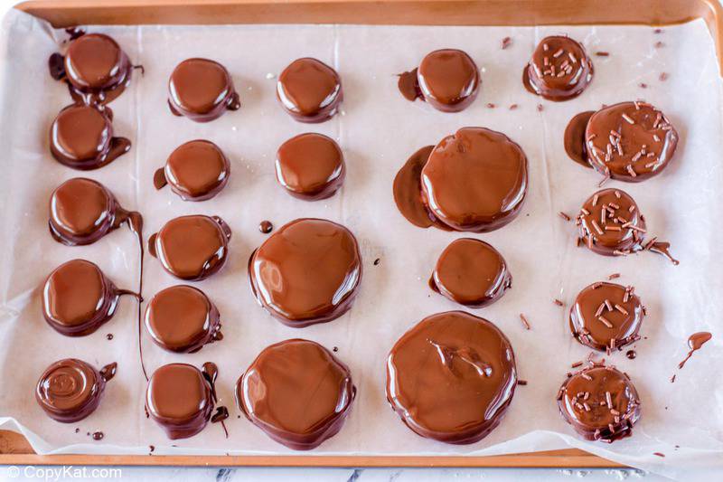chocolate dipped peppermint patties on a baking sheet
