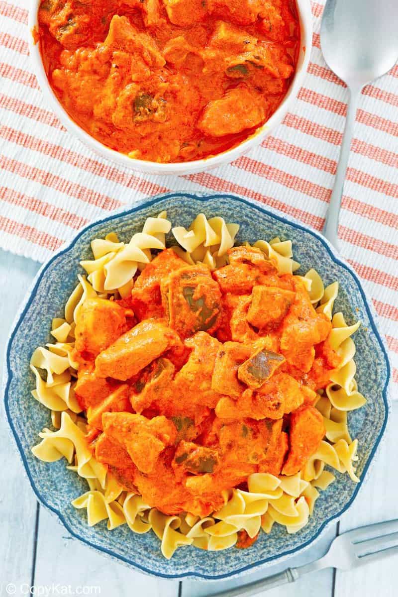 chicken paprikash in a bowl and on noodles