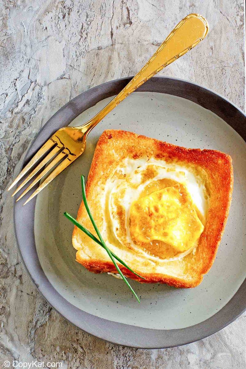 overhead view of egg in a basket and a fork on a plate