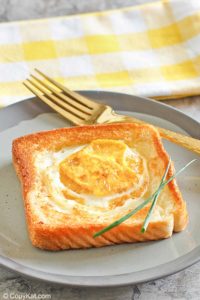 egg in a basket and a fork on a plate