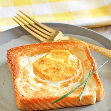 egg in a basket and a fork on a plate