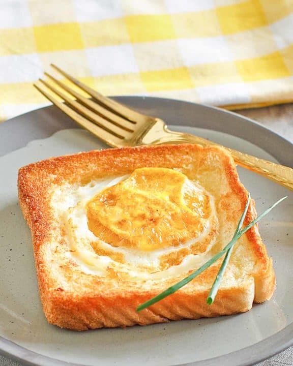 egg in a basket and a fork on a plate