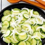 cucumber onion salad in a black bowl
