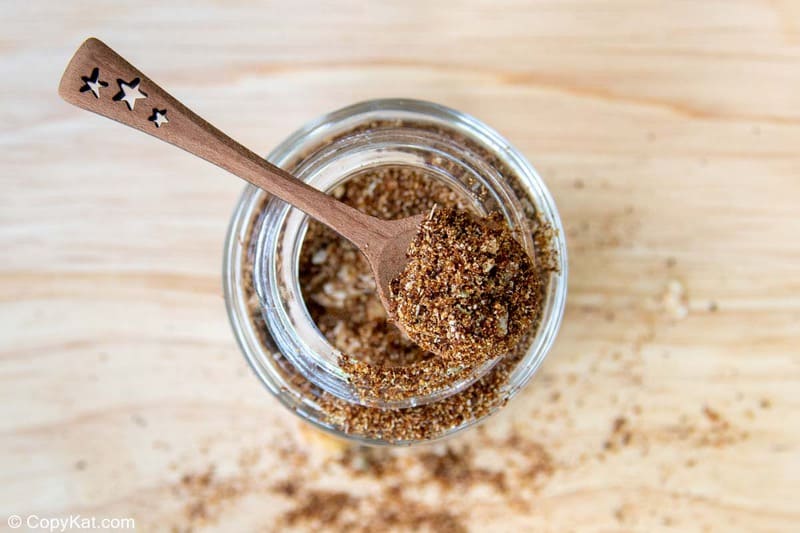 homemade taco seasoning on a small spoon on top of a spice jar