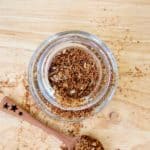 overhead view of homemade taco seasoning in a spice jar and on a spoon