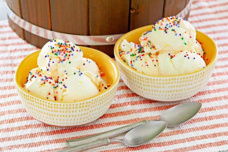 homemade vanilla ice cream in bowls and two spoons