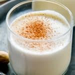 a glass of milk punch topped with nutmeg