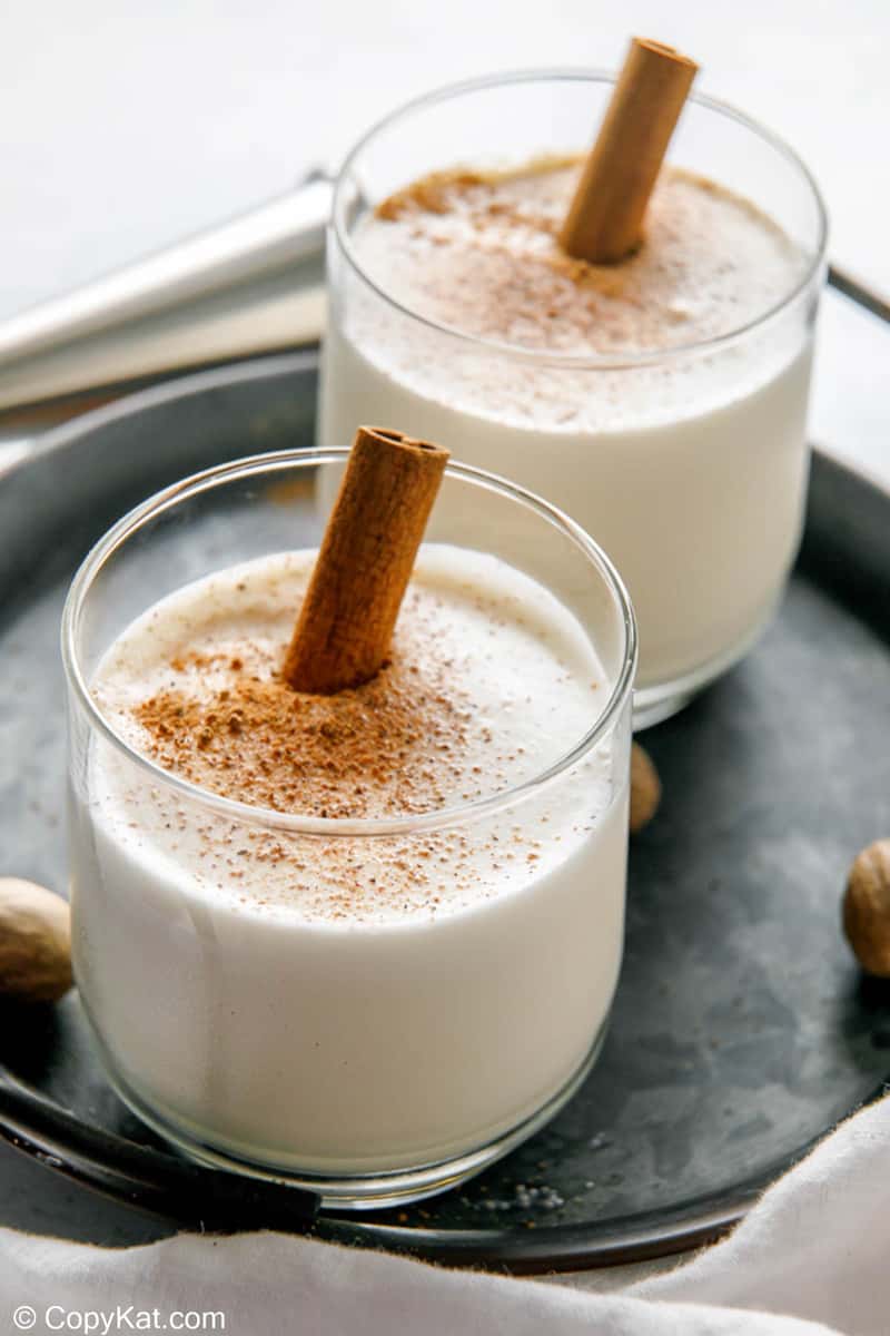 two glasses of milk punch with cinnamon sticks