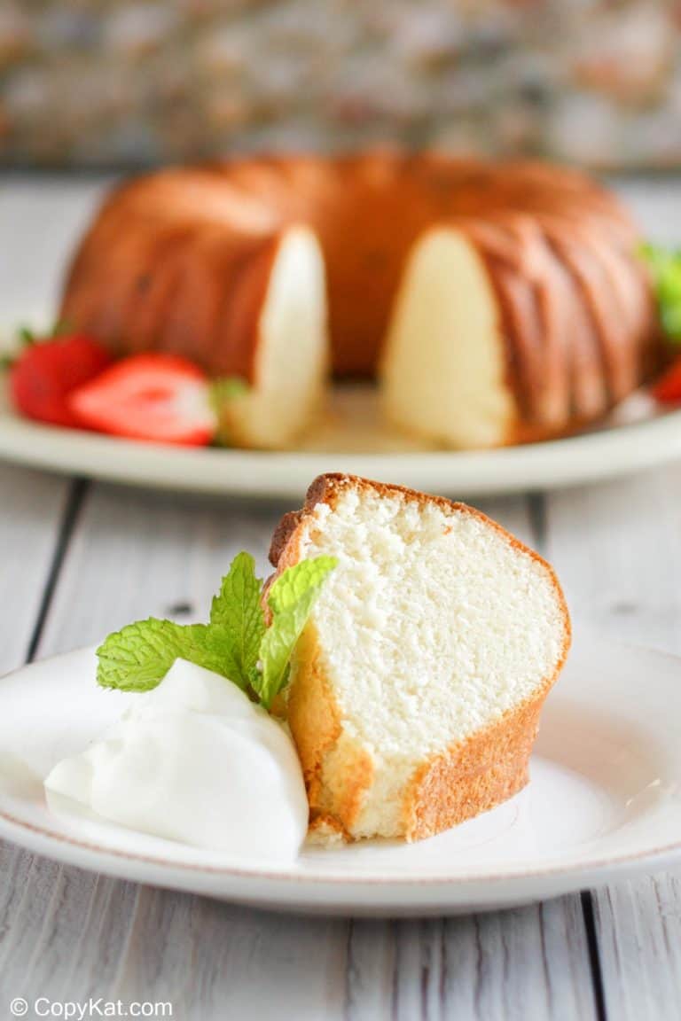 slice of Scandinavian almond cake on a plate in front of the cake