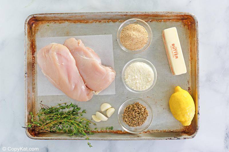 lemon pepper chicken ingredients on a baking sheet.