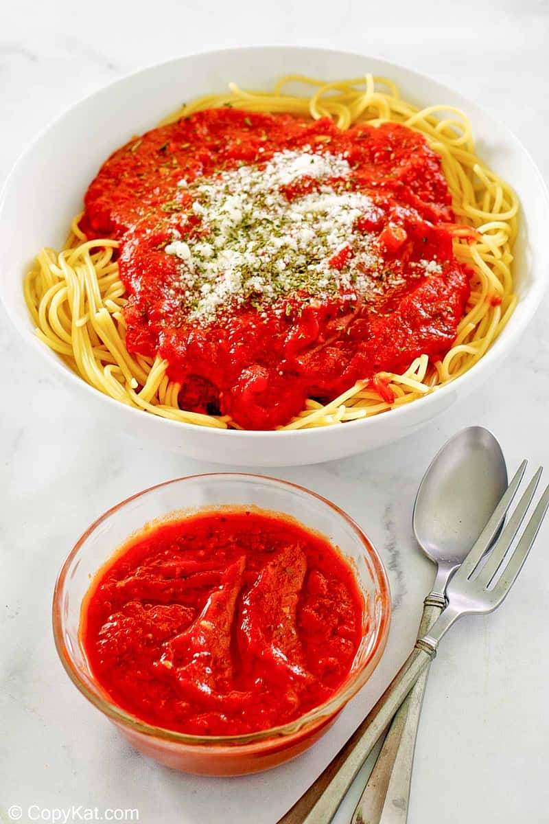 homemade spaghetti sauce in a bowl and on top of spaghetti pasta.