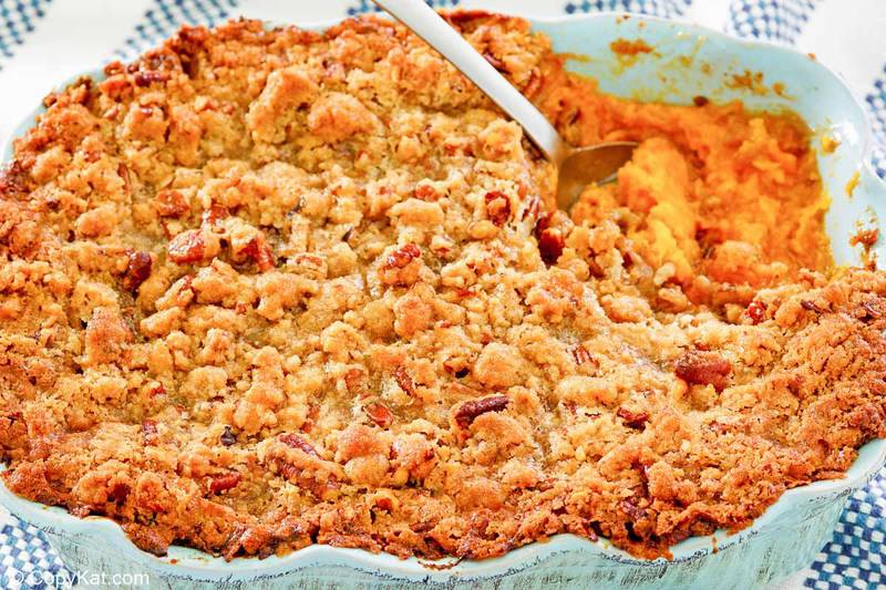 sweet potato souffle with pecans in a blue baking dish.