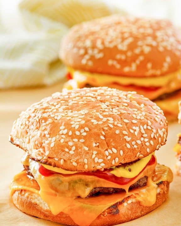 two homemade McDonald's quarter pounder burgers with cheese