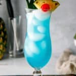 a homemade Olive Garden Blue Hawaiian cocktail in a hurricane glass