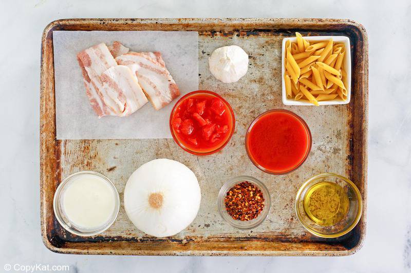 penne alla vodka ingredients on a baking sheet.