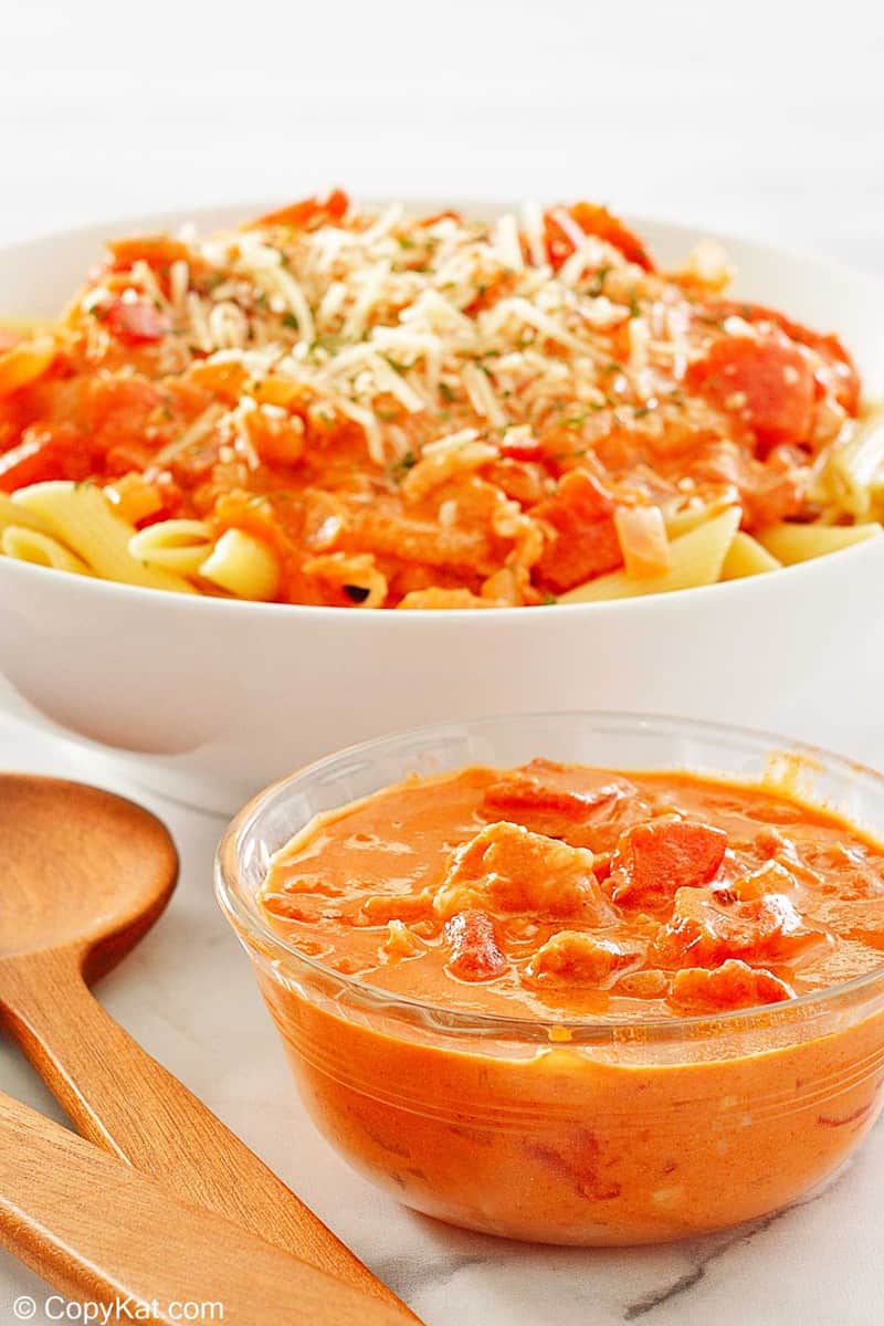a bowl of vodka sauce in front of a bowl of penne alla vodka.