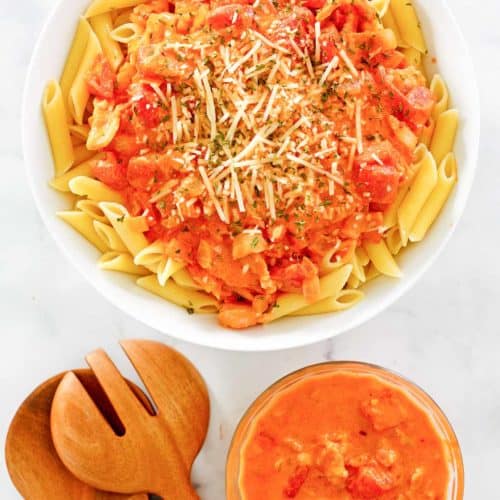overhead view of penne alla vodka and vodka sauce in bowls.