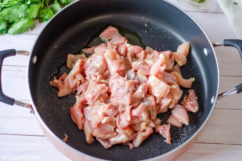 raw chicken pieces and oil in a large skillet.