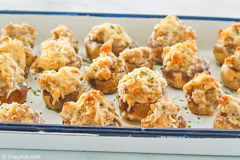 sausage and cream cheese stuffed mushrooms on a serving tray.