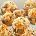 sausage stuffed mushrooms on a serving tray.