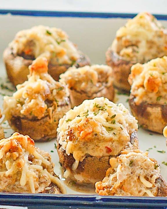 sausage stuffed mushrooms on a serving tray.