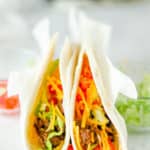 two homemade Taco Bell soft tacos in parchment paper