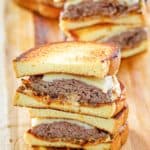 homemade Whataburger patty melt sandwiches on a wood board