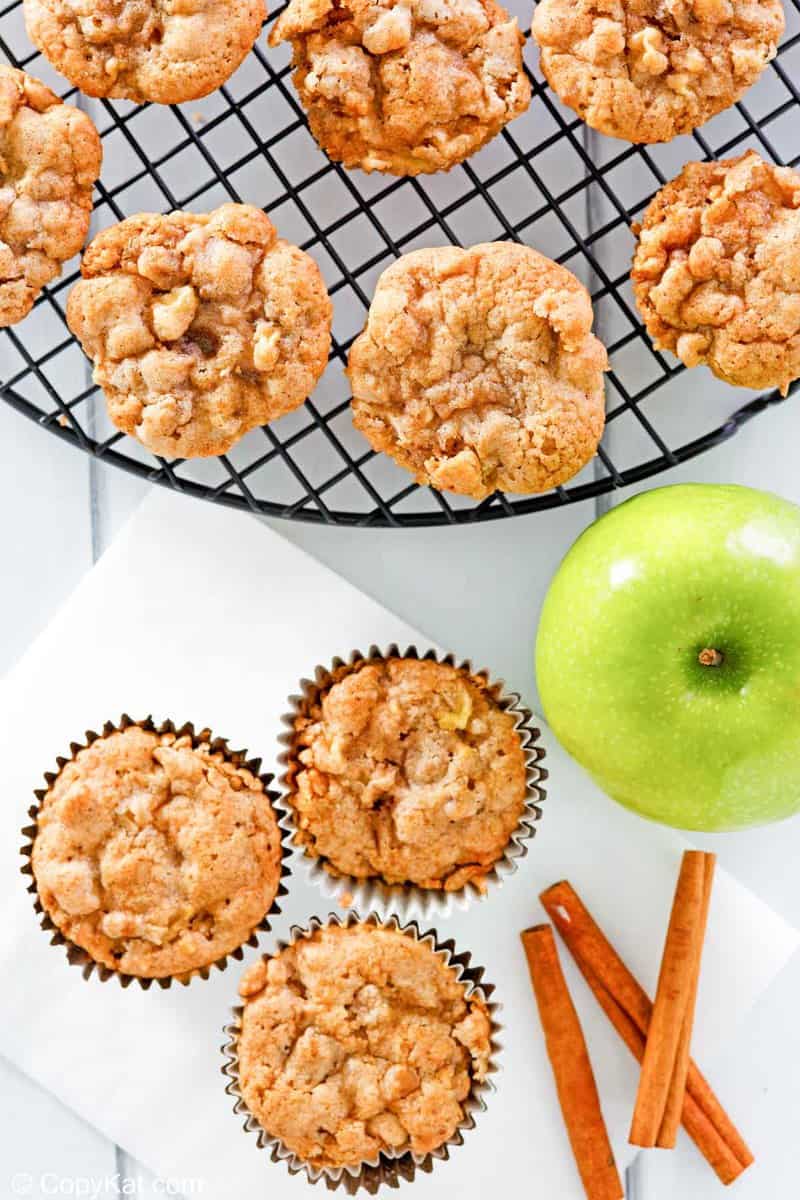overhead view of apple muffins, cinnamon sticks, and an apple