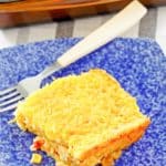 a serving of creamed corn casserole and a fork on a plate