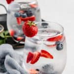 glasses of fruit infused water and fresh fruit.