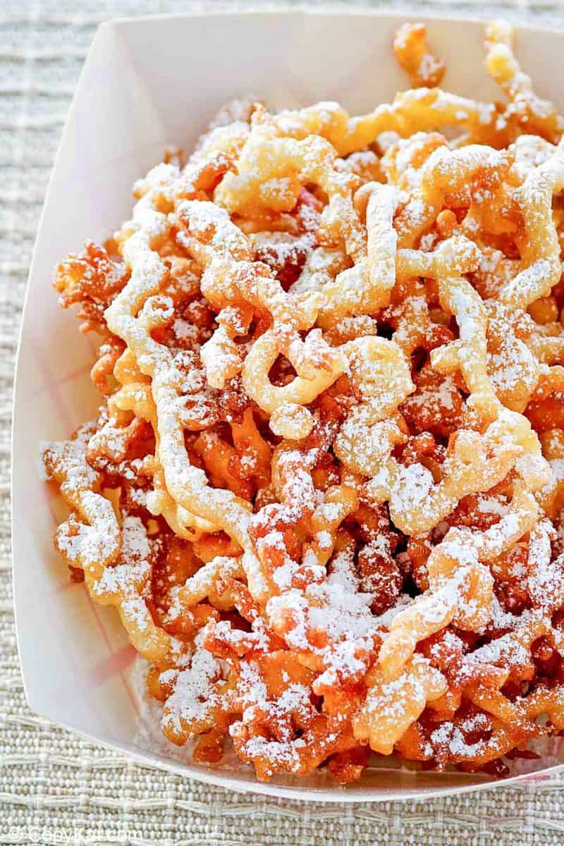 funnel cake fries in a paper serving dish