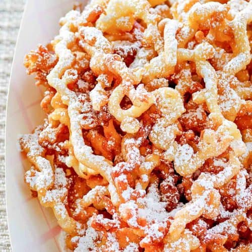 funnel cake fries in a paper serving dish