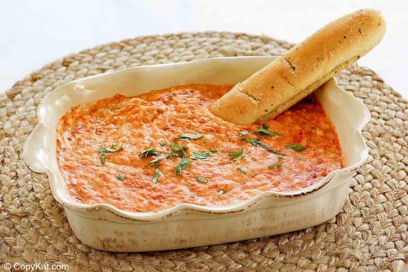 homemade Olive Garden San Remo Seafood Dip and a breadstick in a baking dish