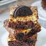 a stack of three Oreo brownies on a plate