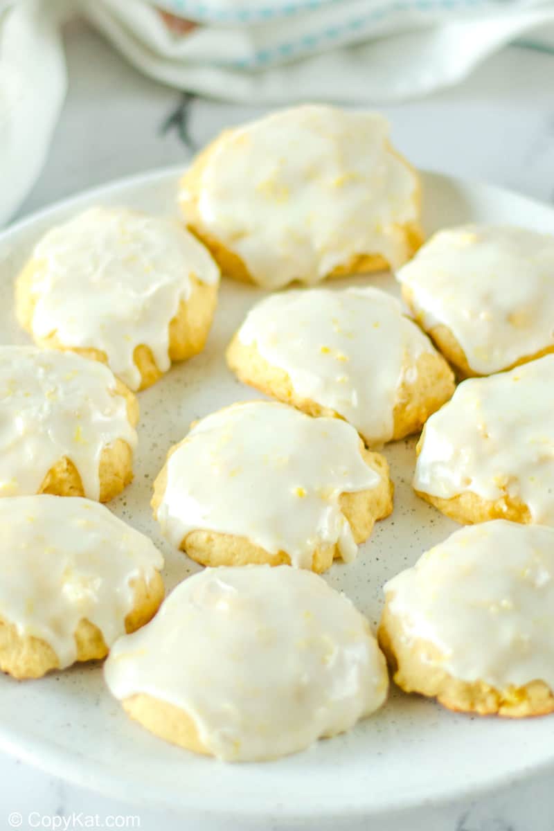ten iced pineapple cookies on a plate