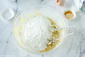adding dry ingredients to creamed butter mixture