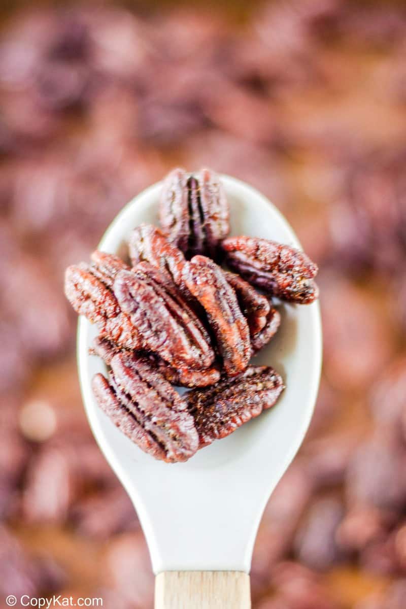 spiced pecans on a large spoon