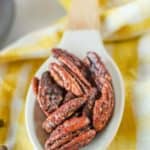 spiced pecans on a white silicone spoon