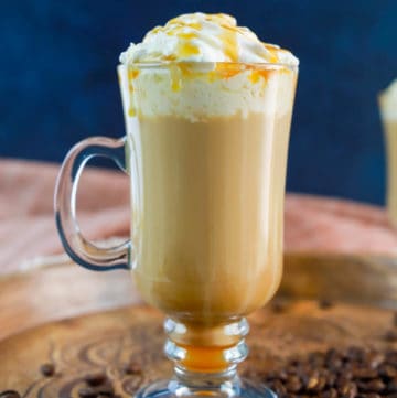 homemade Starbucks caramel macchiato on a wood tray.