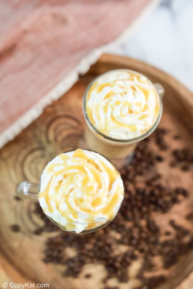 overhead view of two homemade Starbucks caramel macchiato coffee drinks on a tray